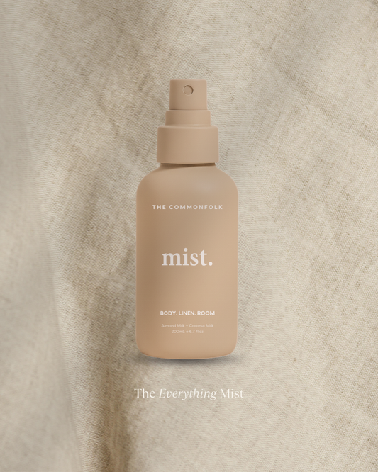 Beige spray bottle labeled 'mist' on a textured beige background