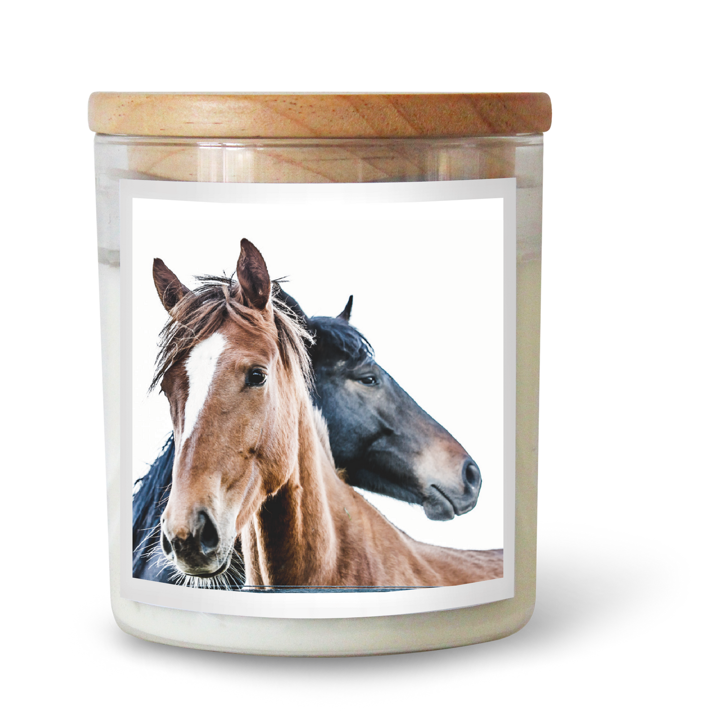 The Commonfolk scented candle has a label featuring two horses, one brown and one black, with a wooden lid on top.