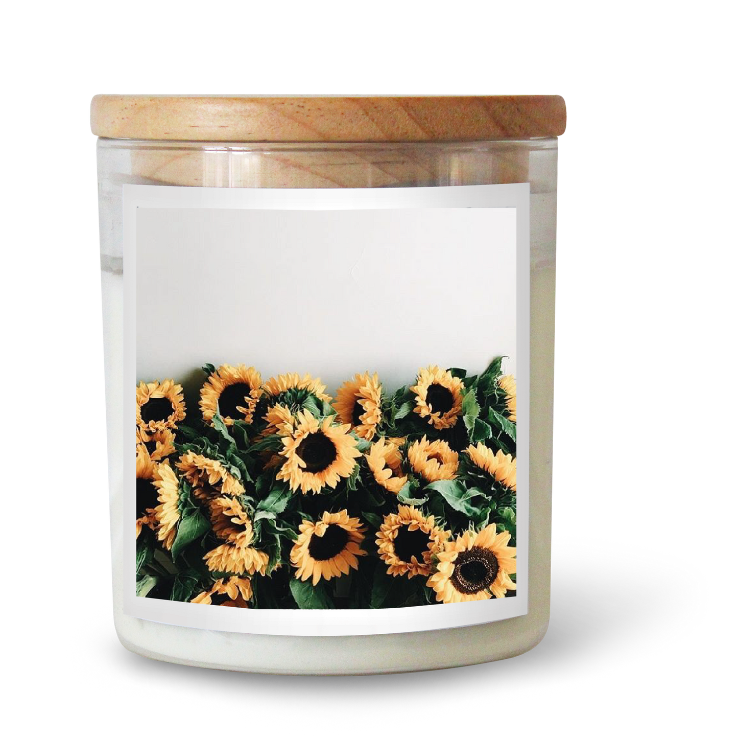 The Commonfolk scented candle comes in a clear jar with a wooden lid, featuring an image of sunflowers on the label.
