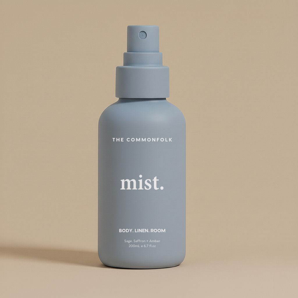 Denim color spray bottle labeled 'mist' by The Commonfolk on a beige background