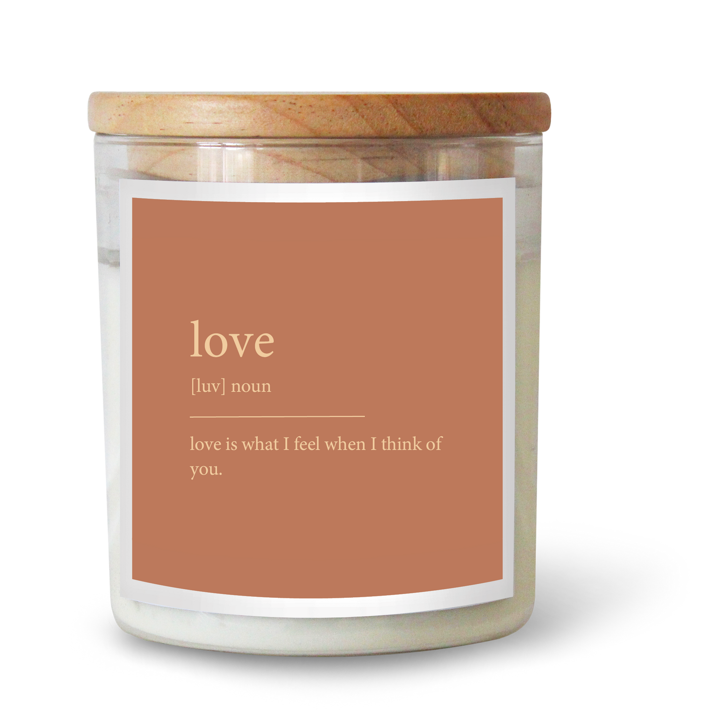 The Commonfolk scented white candle with a wooden lid and a label that reads 'love' and has a definition below it.