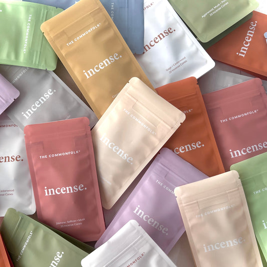 Collection of 'incense.' packaging in various colors on a white background