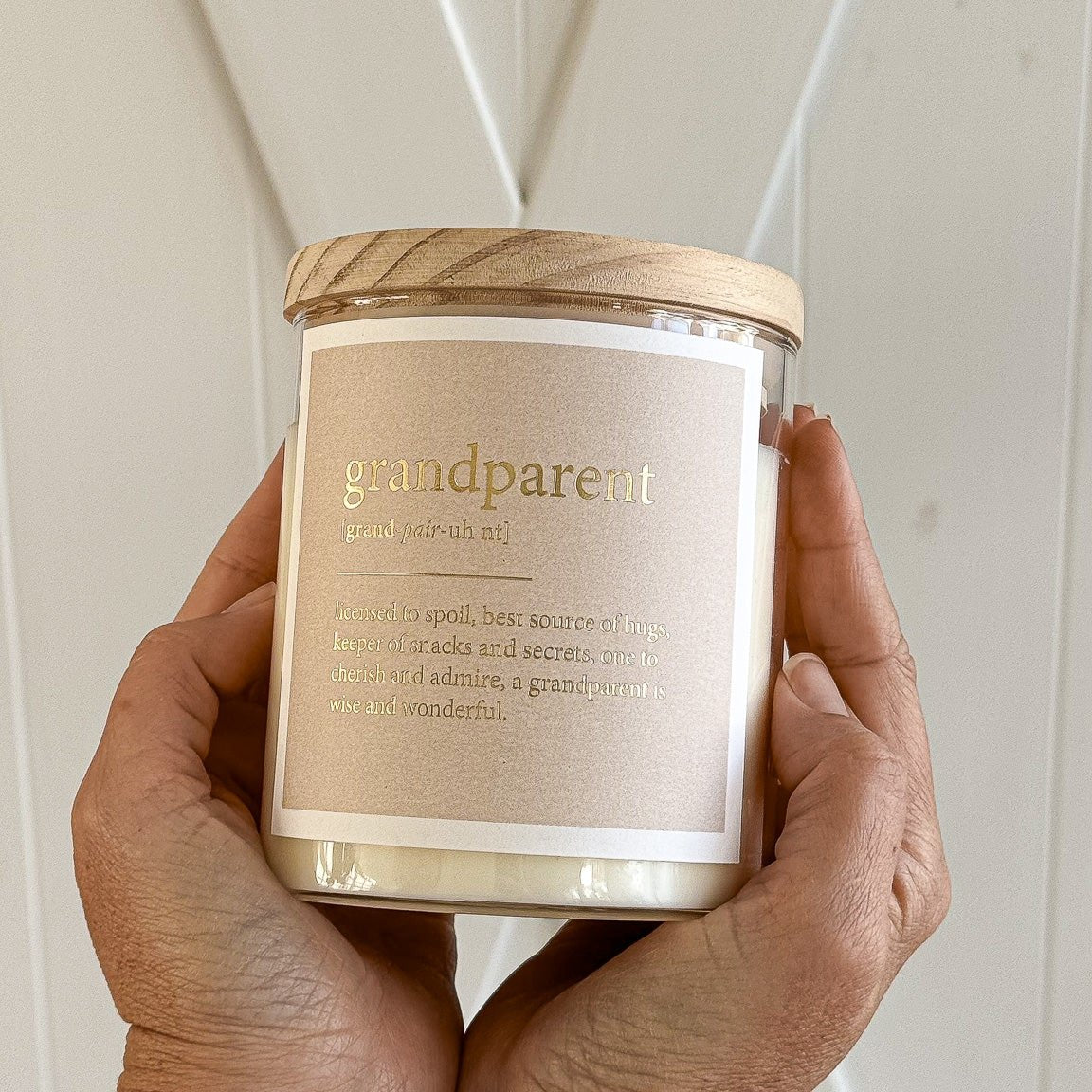 A decorative candle with a warm glow, symbolizing love and memories shared with grandparents.