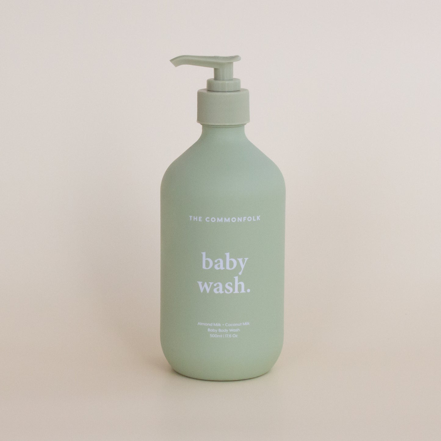 The Commonfolk matte finish 500ml bottle of baby wash with a pump dispenser, labeled 'baby wash', in a sage green color.