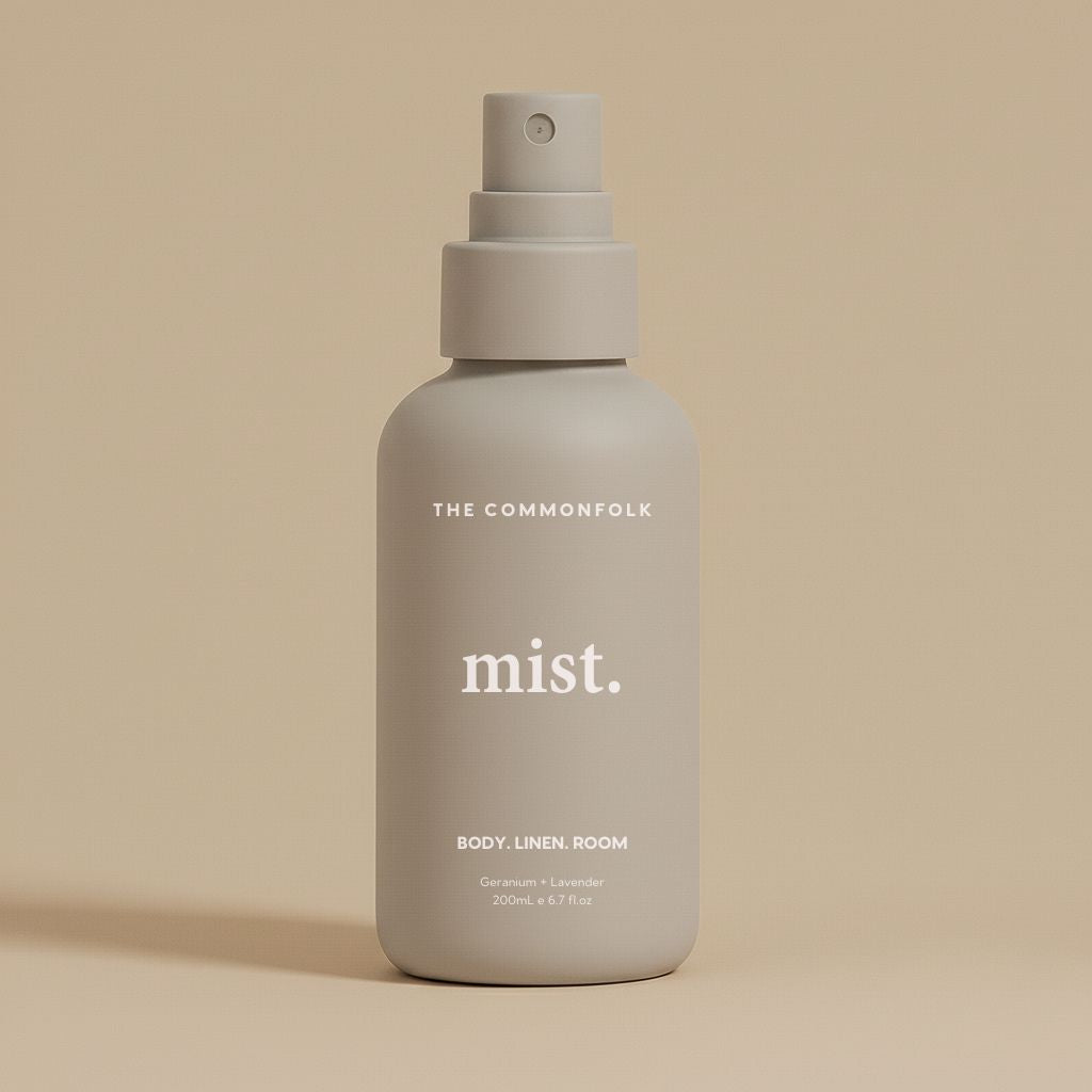 Gray spray bottle labeled 'mist' by 'The Commonfolk' on a beige background