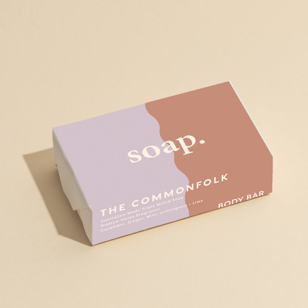 The Commonfolk 200g body bar soap has a simple design, featuring a duotone color scheme with the word 'soap' on it, placed on a neutral background.