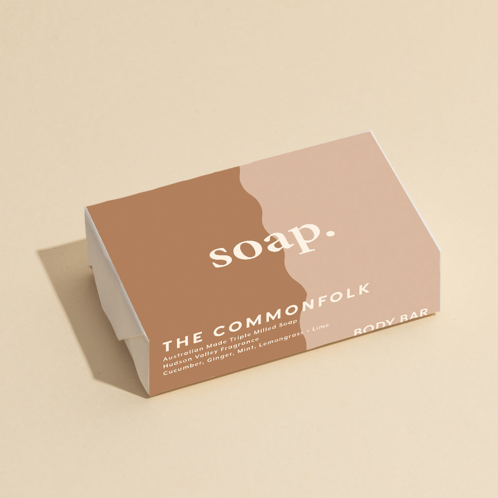 The Commonfolk 200g body bar soap is labeled 'soap' with a minimalist design, featuring a nude color and wave pattern on the packaging.