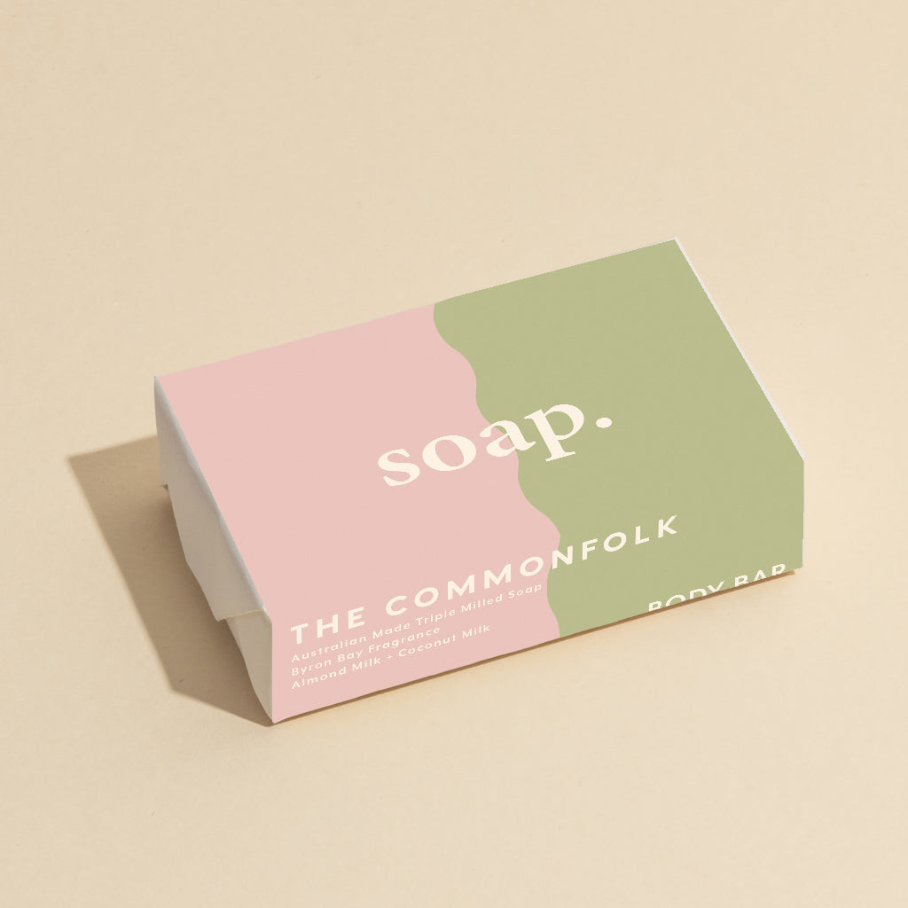 The Commonfolk 200g body bar soap with pink and sage color blocks, and the text 'soap' printed on it.