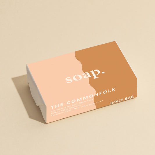 The Commonfolk 200g body bar soap has a simple design, predominantly in shades of pink and brown, with the text 'soap' printed on it.
