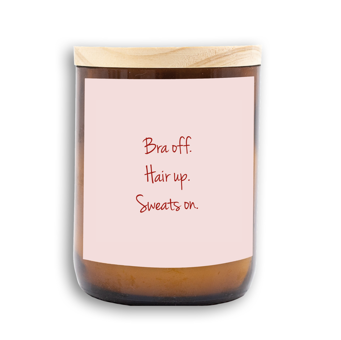 The Commonfolk scented white wax candle has a wooden lid with a label that reads 'Bra off. Hair up. Sweats on.'