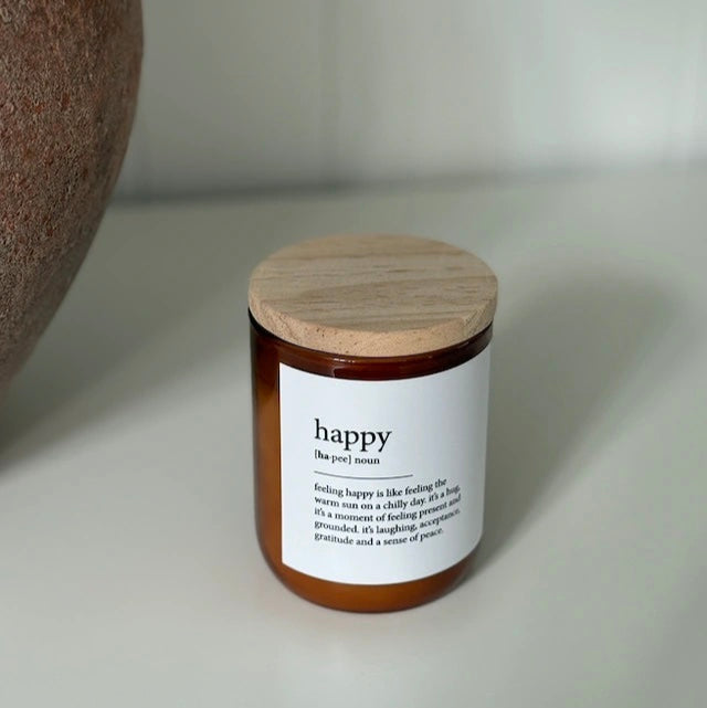 Candle with a wooden lid and label on a neutral background
