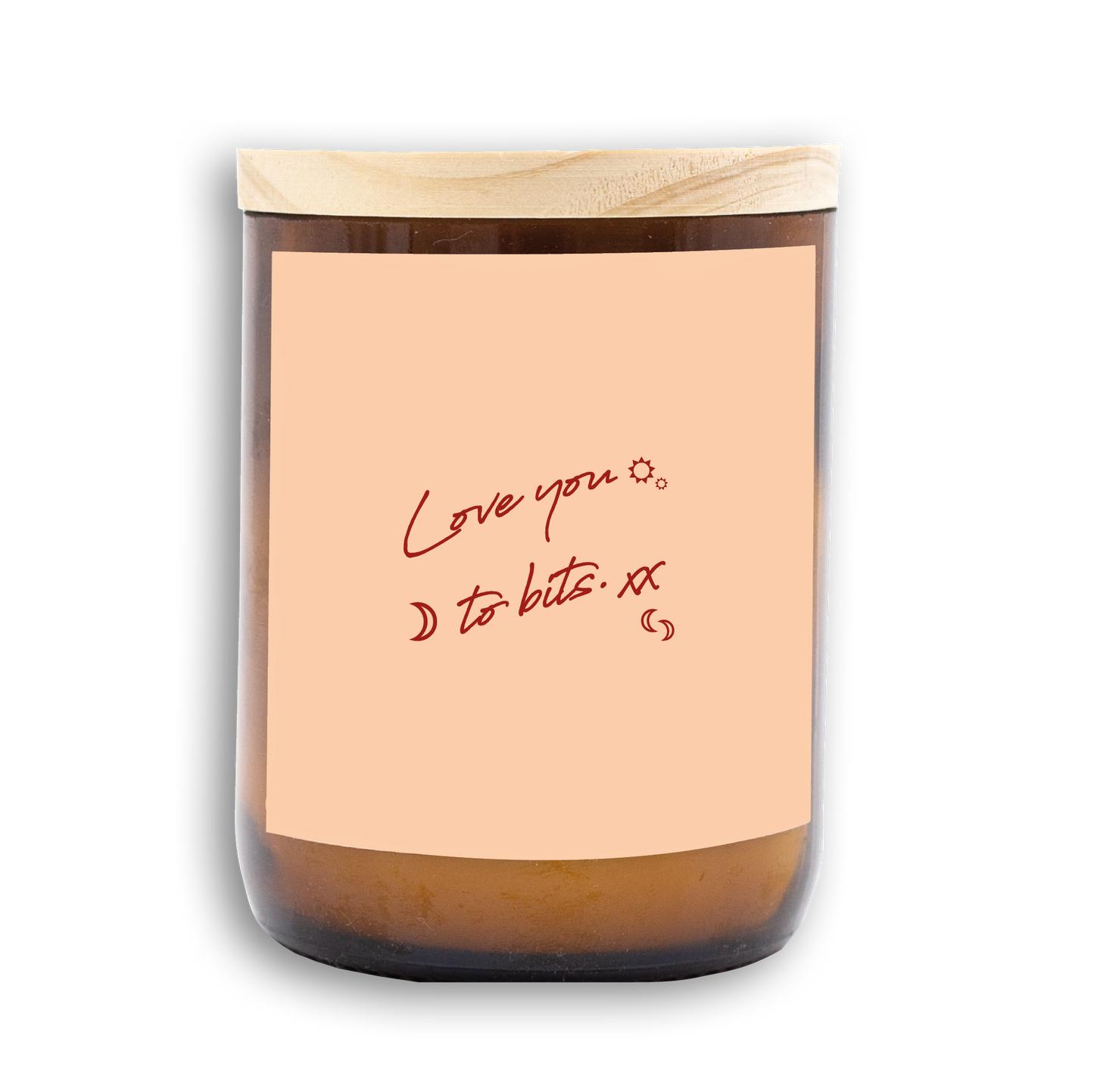 The Commonfolk scented candle has a beige label with the text 'Love you to bits' written in a red, cursive font. The candle wax is visible at the bottom, and there is a wooden lid on top.