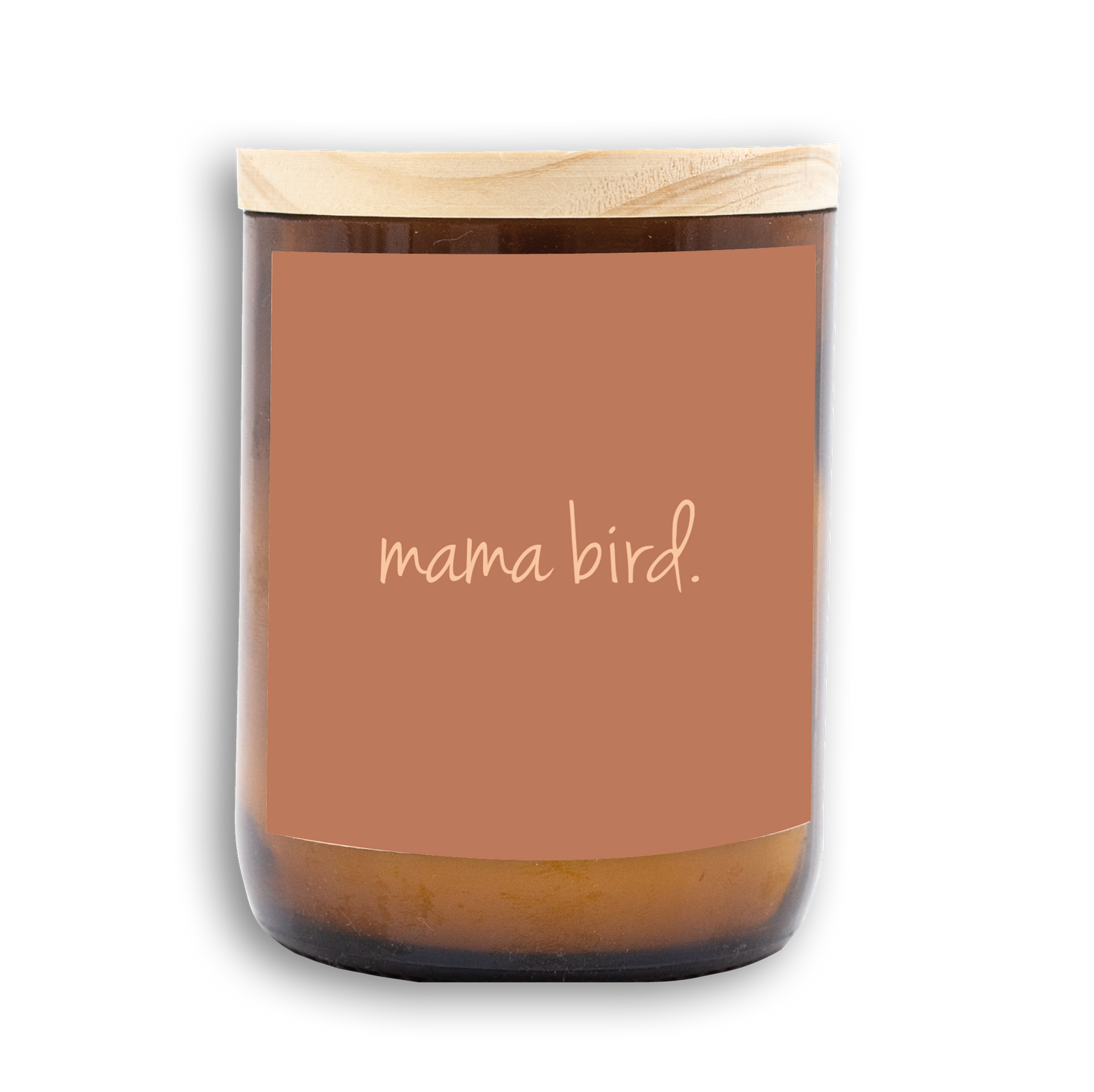 The Commonfolk scented candle with a wooden lid and amber jar, the label shows the text 'mama bird.'