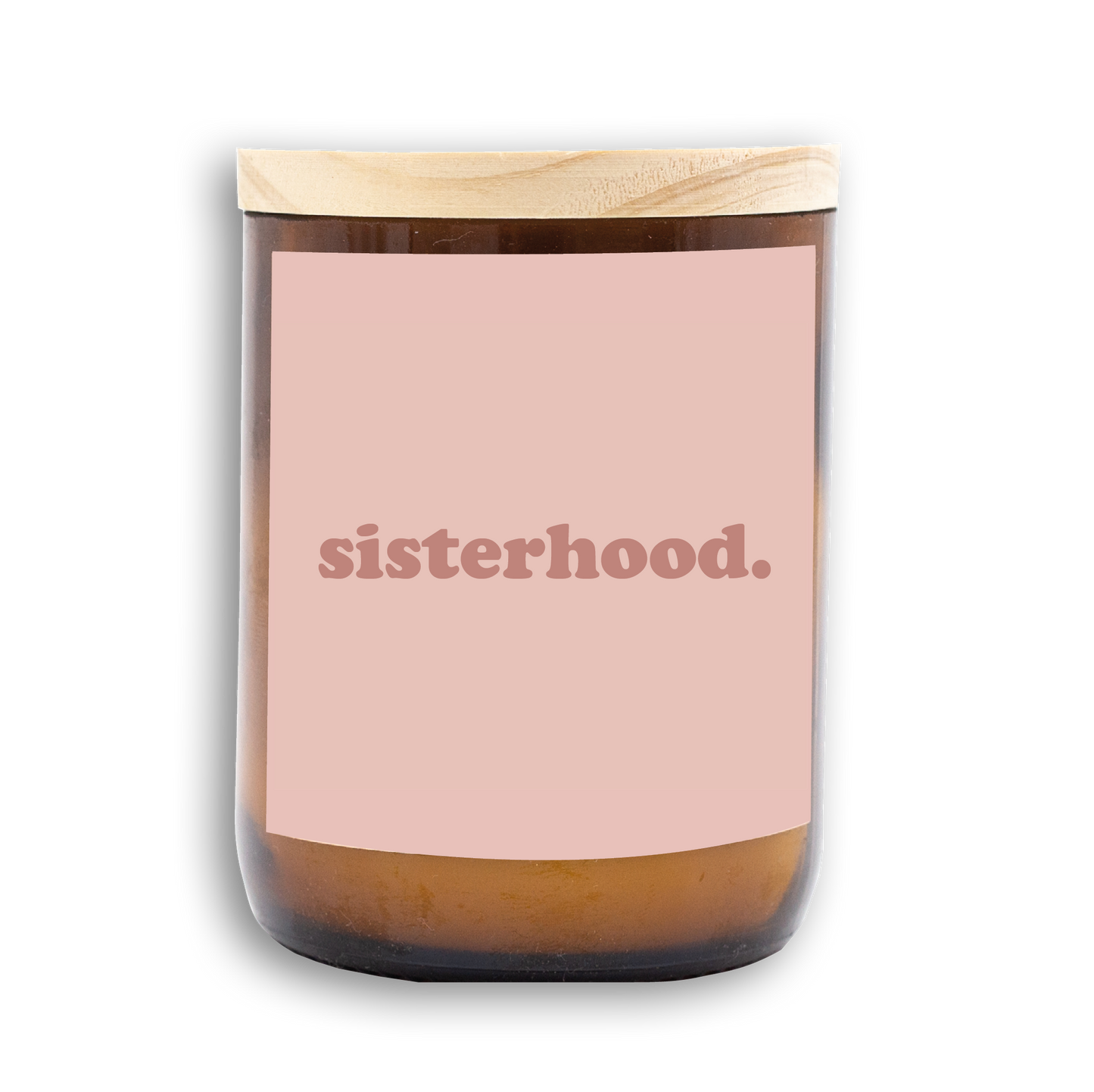 The Commonfolk scented candle features a wooden lid, an amber glass jar, and a pink label that reads 'sisterhood.'