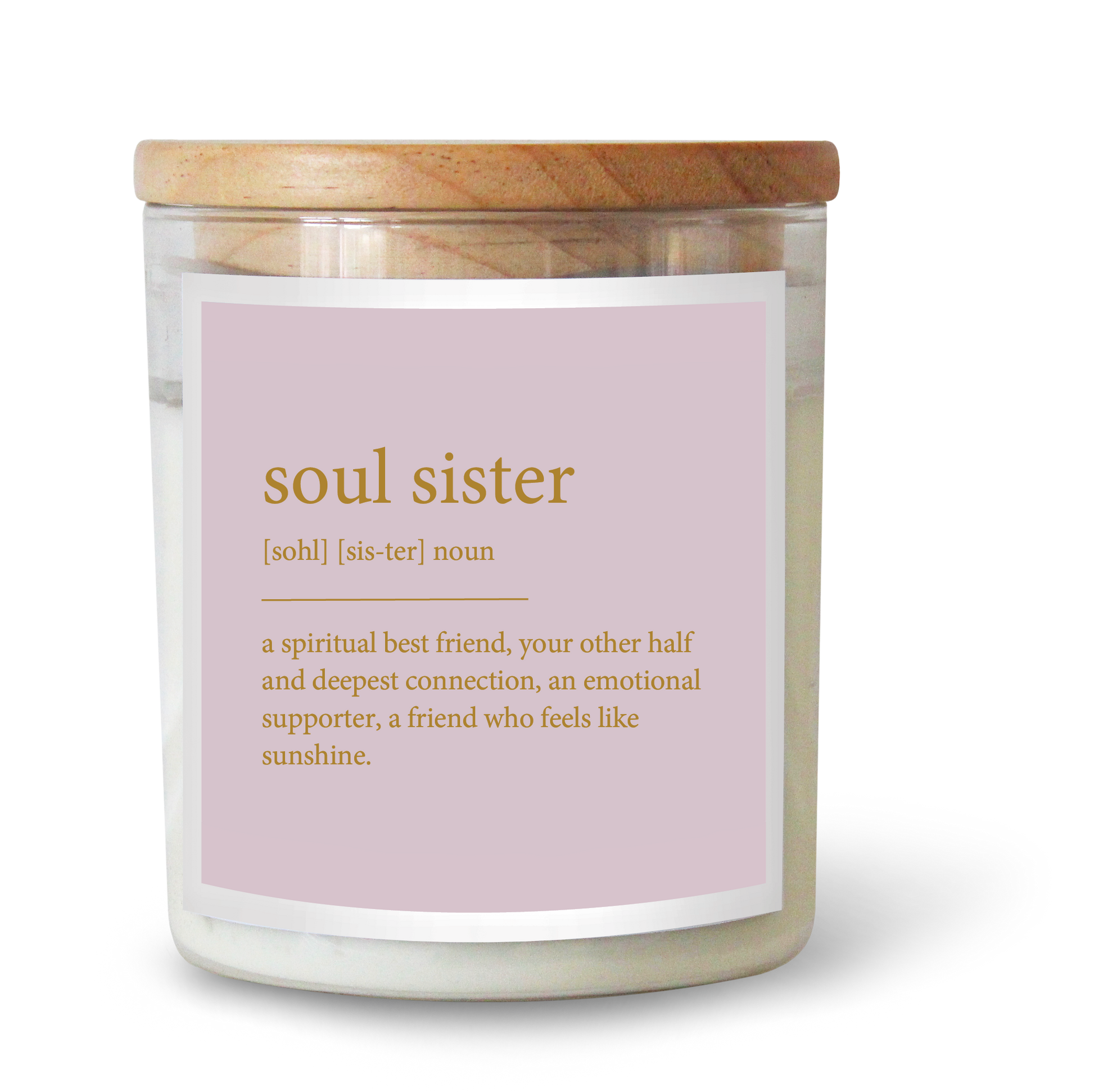 The Commonfolk scented candle features a label that defines 'soul sister'. The candle has a clear container, a wooden lid, and a pink label with gold text.