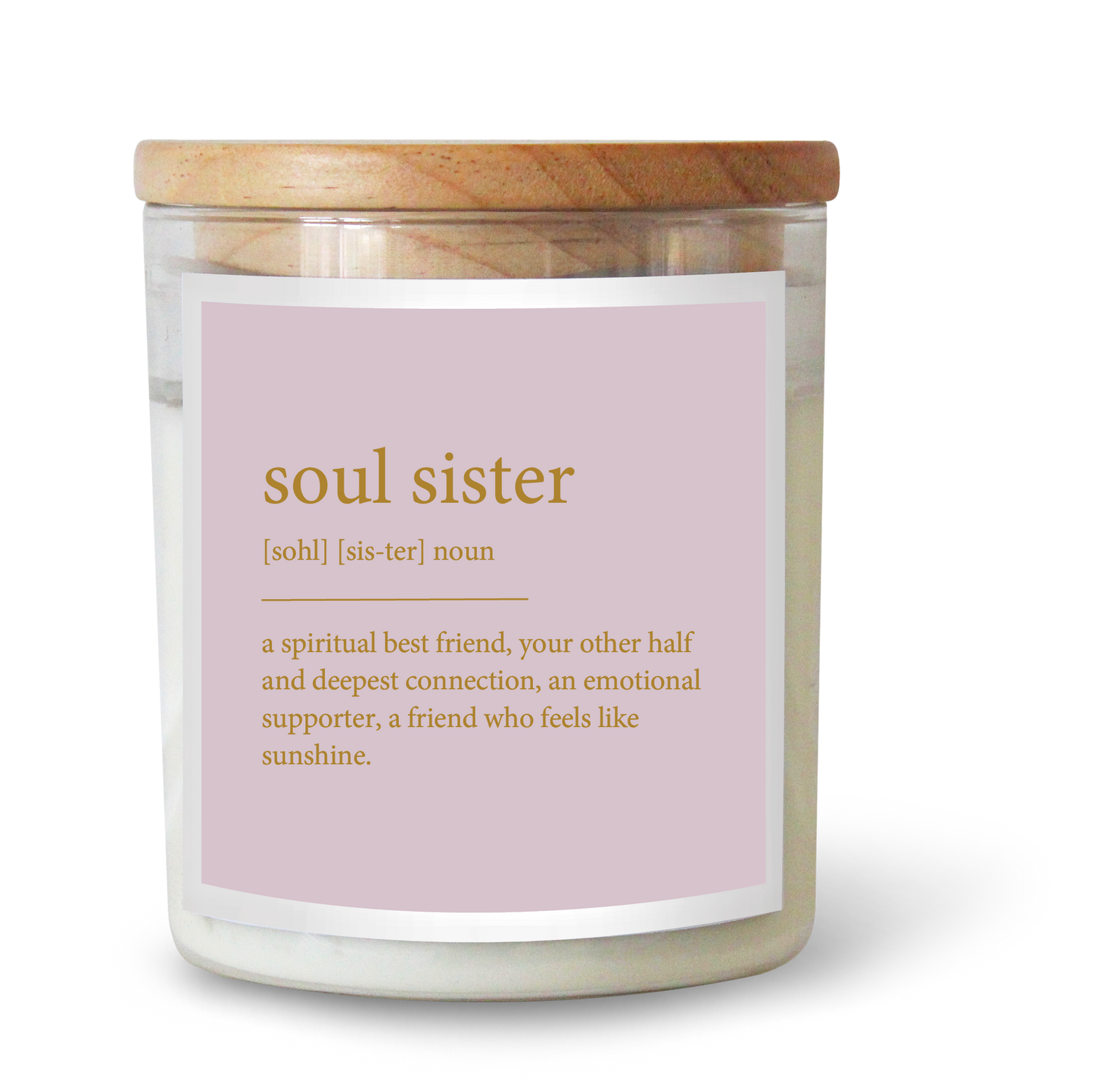 The Commonfolk scented candle features a label that defines 'soul sister'. The candle has a clear container, a wooden lid, and a pink label with gold text.