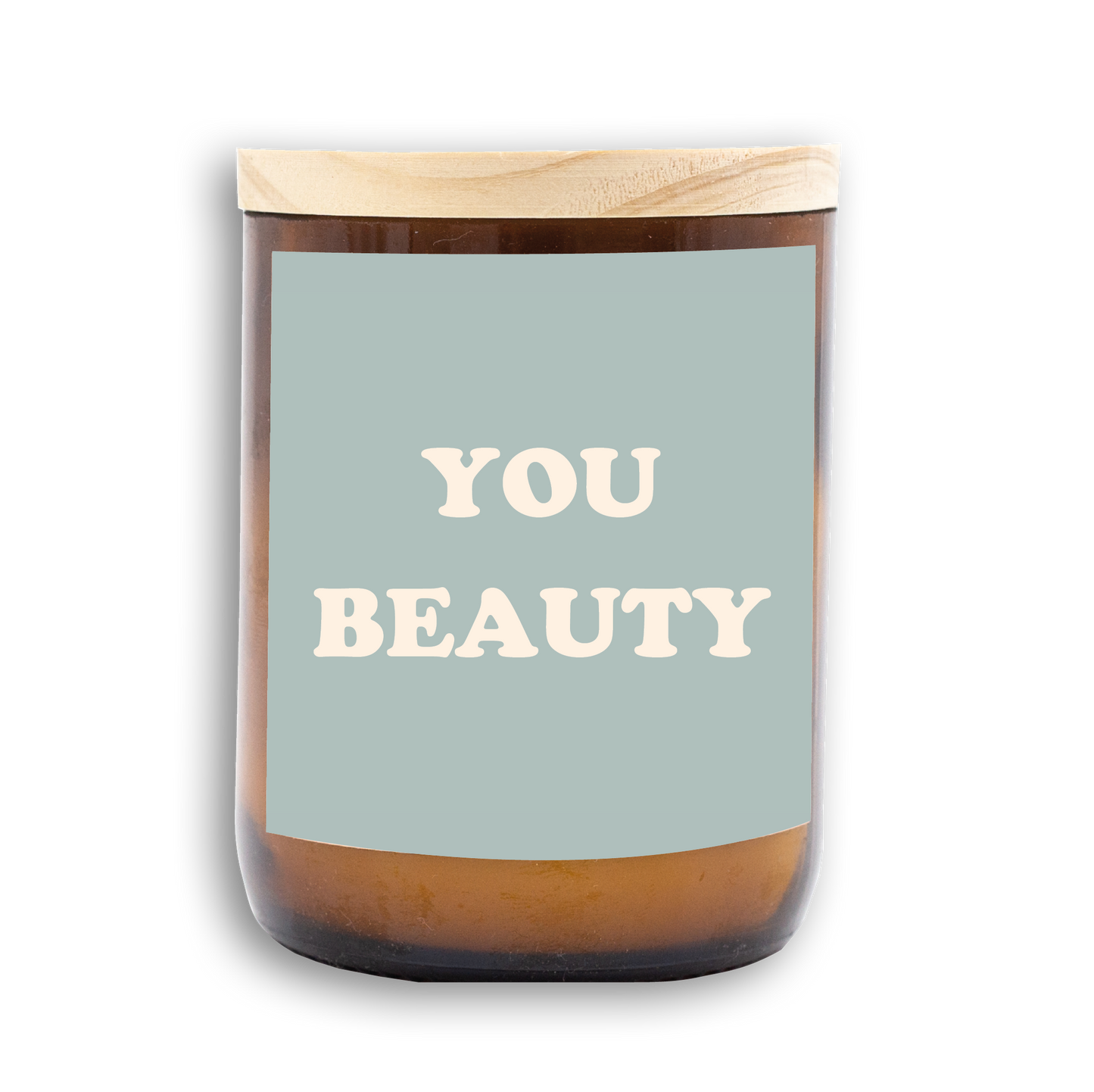 The Commonfolk scented candle with a wooden lid, white wax, and a label that reads 'YOU BEAUTY'.