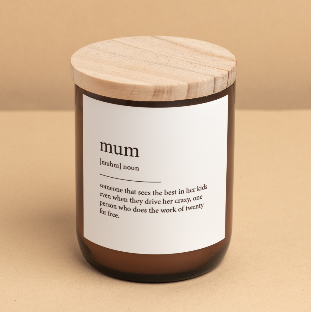 The Commonfolk scented candle in an amber jar with a wooden lid, labeled 'mum' which stands for 'mother'.