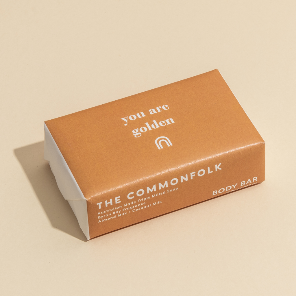 The Commonfolk 200g body bar soap packaging features the text 'you are golden' on the top of the brown wrapper.