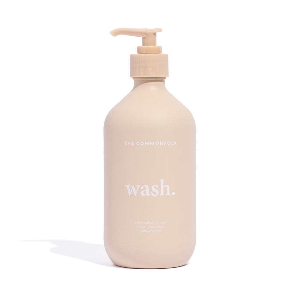 The Commonfolk matte nude 500ml bottle of hand and body wash with a pump dispenser is labeled 'wash.'