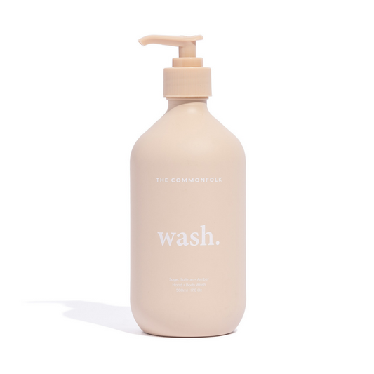 The Commonfolk matte nude 500ml bottle of hand and body wash with a pump dispenser is labeled 'wash.'