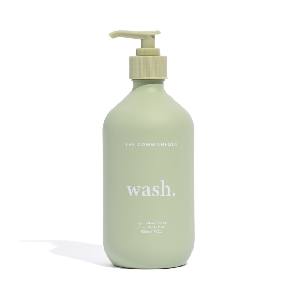 The Commonfolk matte green 500ml bottle of hand and body wash with a pump dispenser, labeled 'wash.'
