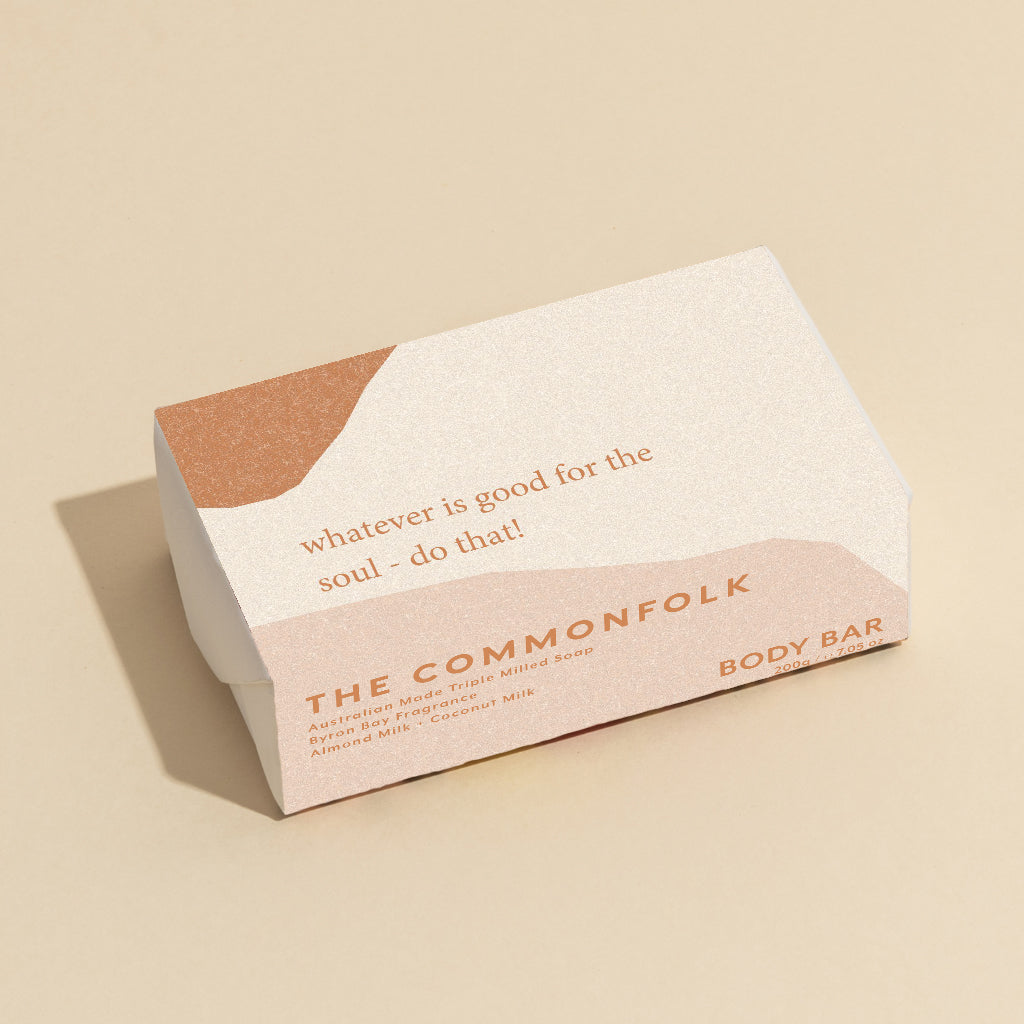 The Commonfolk 200g body bar soap has the text 'whatever is good for the soul - do that!' on the top. The packaging is in white with a beige section.