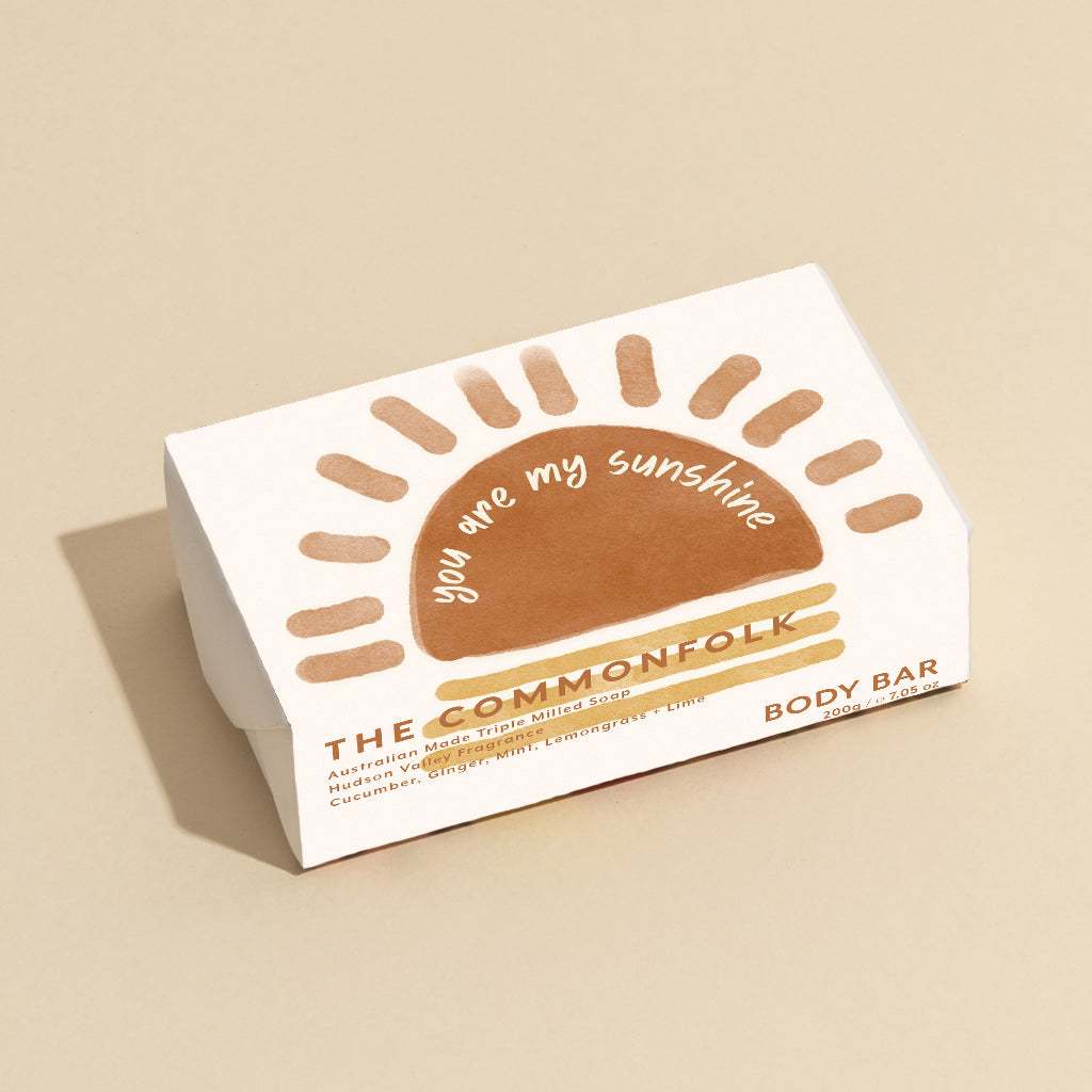 The Commonfolk 200g body bar soap features a white and brown color scheme with the text 'you are my sunshine' on the top.