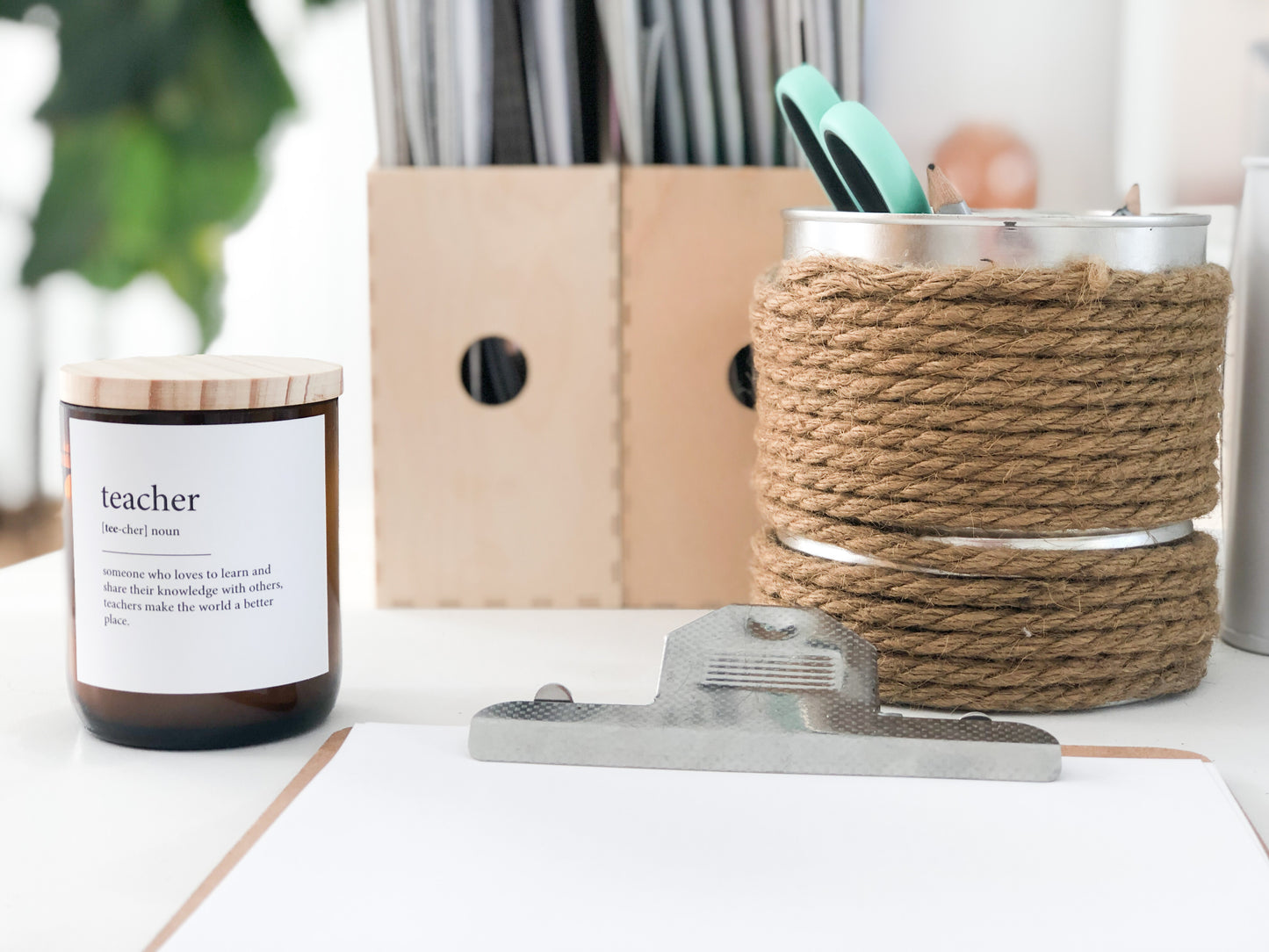 A decorative candle labeled "teacher," symbolizing appreciation for educators, with a warm glow and inviting design.