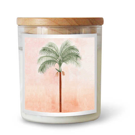 The Commonfolk scented candle, with a palm tree illustration on its label, features a wooden lid and a pinkish-hued background.