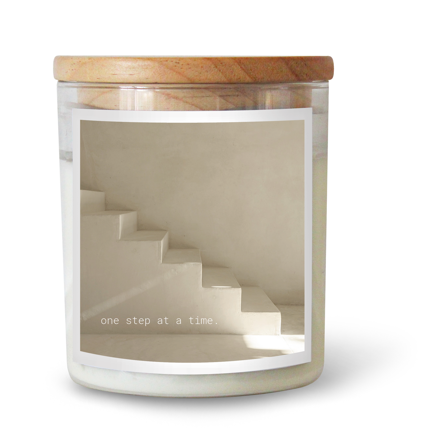 The Commonfolk scented candle with a white label, features a staircase design and the text 'one step at a time'.