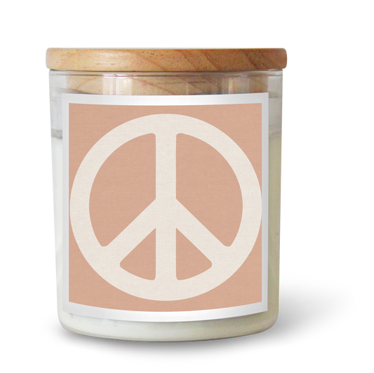 The Commonfolk scented candle with a pink label featuring a peace sign is set in a clear jar with a wooden lid.