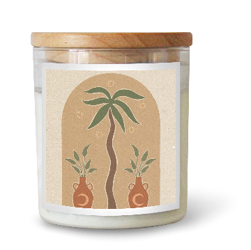 The Commonfolk scented candle features a beige label with artistic palm trees and pots, topped with a wooden lid.