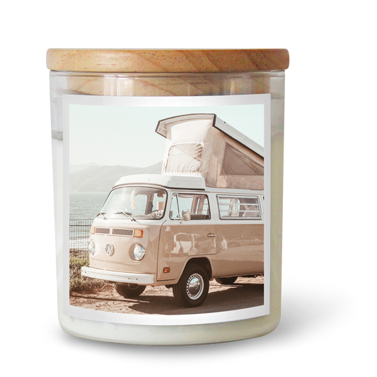 The Commonfolk scented candle features an image of a vintage kombi van printed on its jar, with a wooden lid on top.
