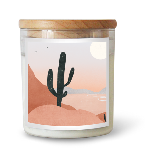 The Commonfolk scented candle with an illustration of a cactus and a moon in the desert on its label, with a wooden lid.