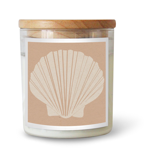The Commonfolk scented candle features a clear jar with a fan shell design in a nude color, set against a neutral background.