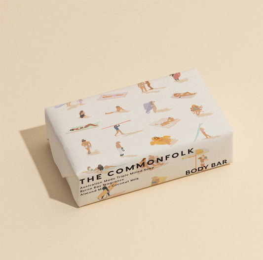 The Commonfolk 200g body bar soap, with illustrations of people in a beach setting on the wrapping.