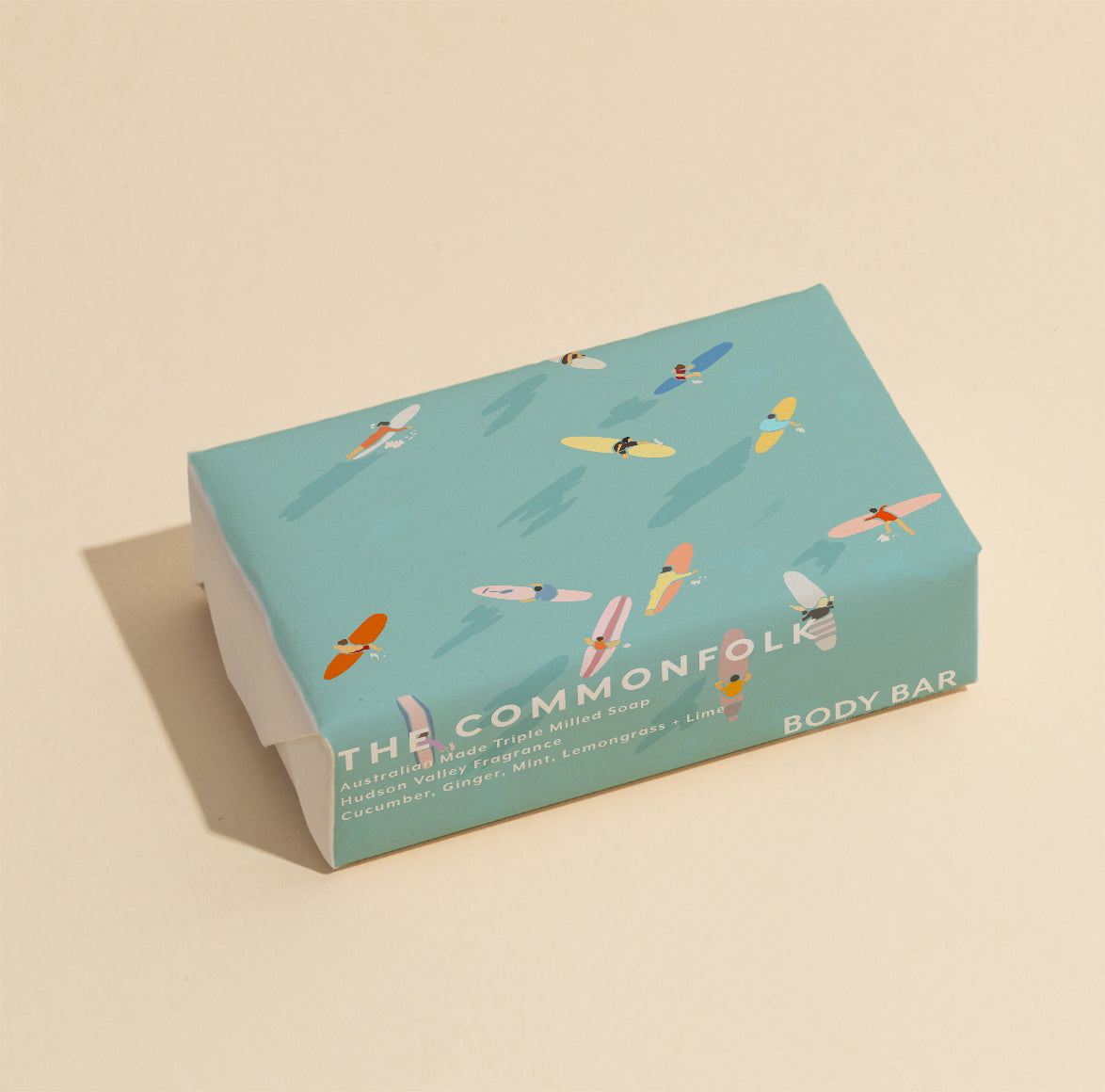 The Commonfolk 200g body bar soap with a blue wrapper featuring illustrations of surfers.