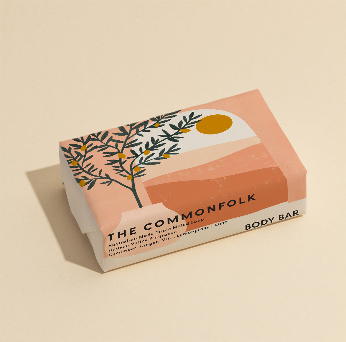 The Commonfolk 200g body bar soap features a pink and yellow color scheme and an illustration of a lemon tree.