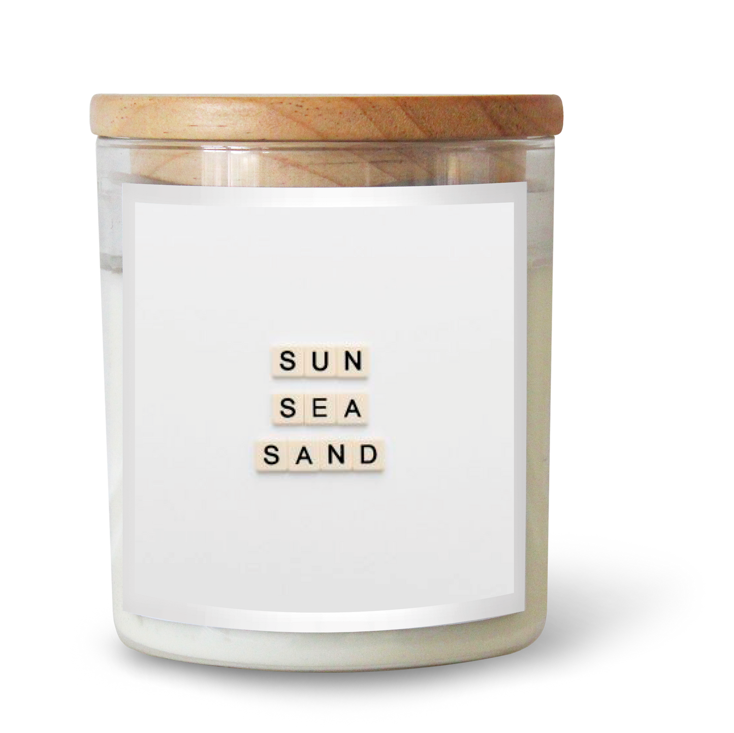 The Commonfolk scented white candle with the text 'SUN SEA SAND' on the label is contained in a clear glass jar with a wooden lid.