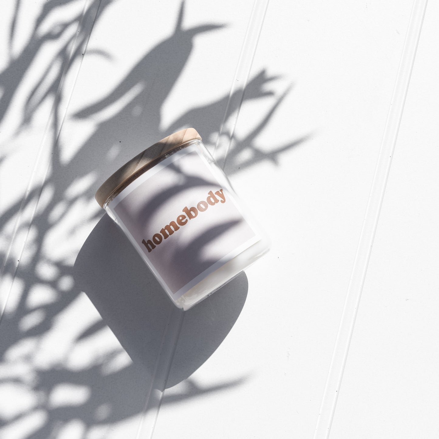 Scented candle in a cozy setting, symbolizing comfort and relaxation for a homebody.