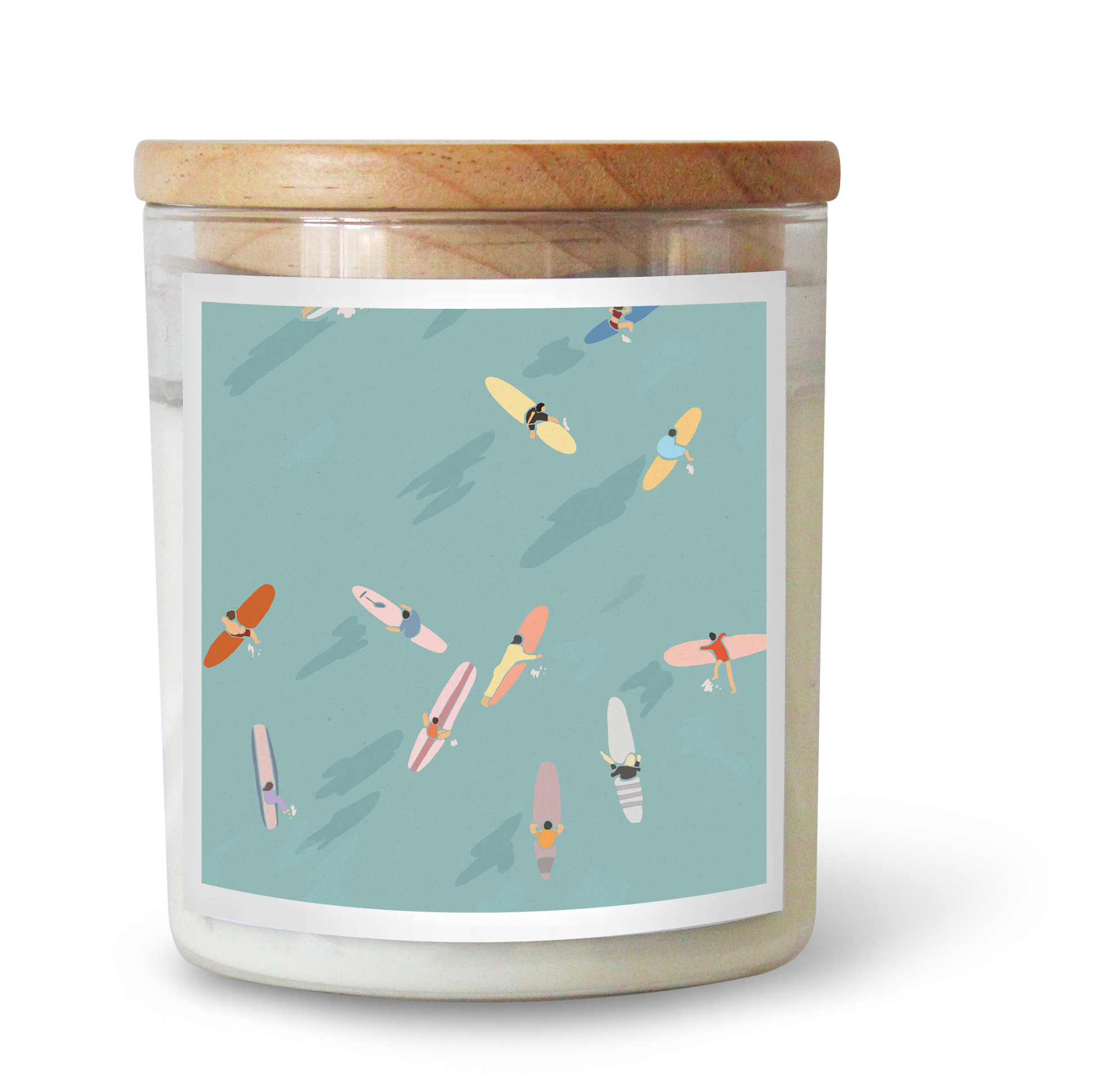 The Commonfolk scented candle features a label with multiple surfboards in various colors on a light blue background, topped with a wooden lid.