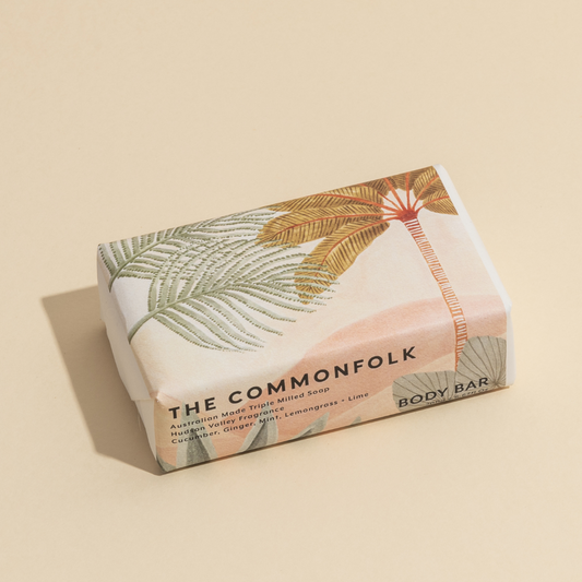 The Commonfolk 200g body bar soap features a botanical design and landscape. The packaging is hand-wrapped in recycled paper.