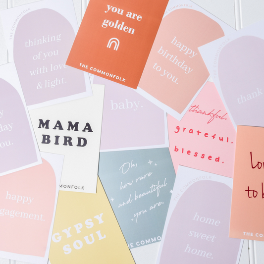 The Commonfolk scented collection of colorful, personalized greeting cards with various messages written on them.