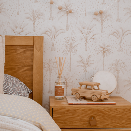 A stylish bed with a wooden nightstand and a room diffuser contributes to a serene and organized bedroom setting.