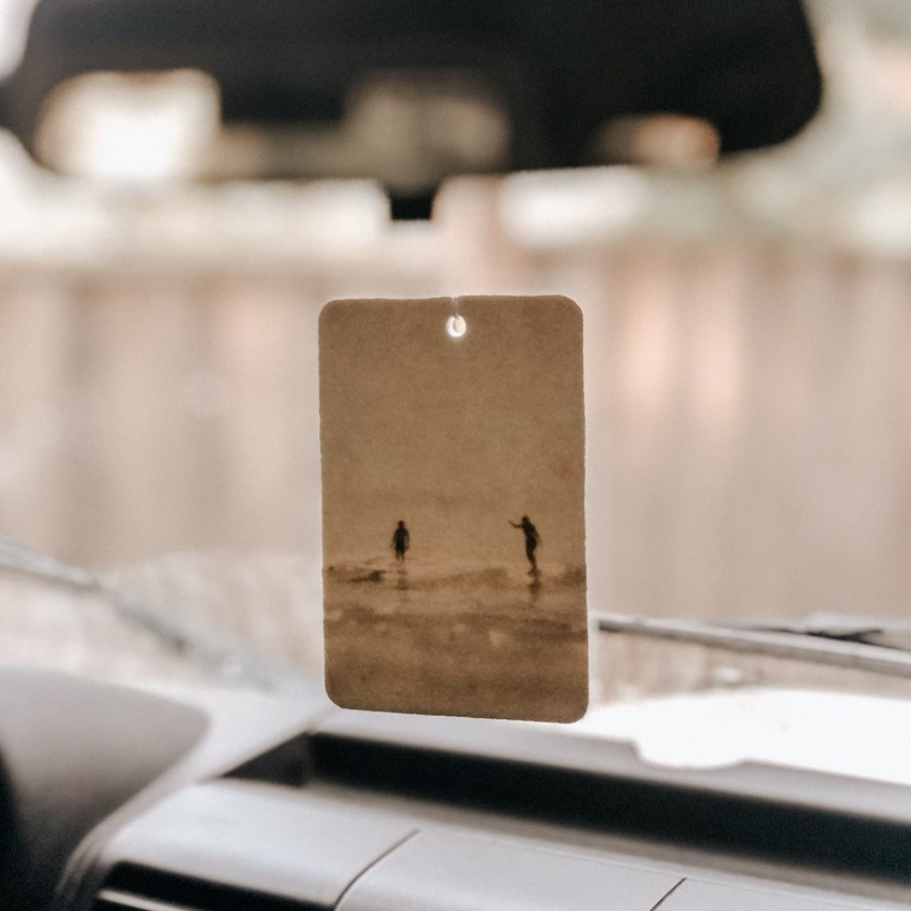 Car dashboard with a hanging air freshener.