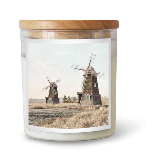 The Commonfolk scented candle features a label with two windmills in a countryside setting.