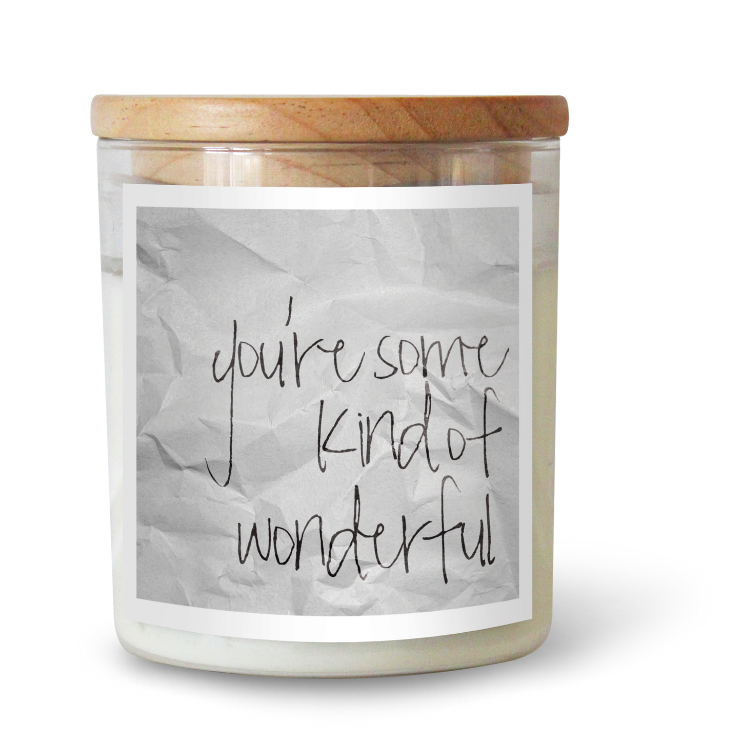 The Commonfolk scented white candle with a wooden lid and a label that reads 'you're some kind of wonderful' in a crumpled paper style font.