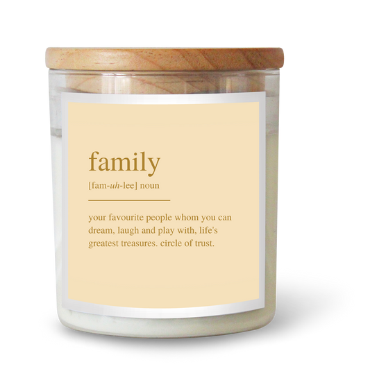 The Commonfolk scented white candle with a wooden lid, and a label that defines 'family' as 'your favourite people whom you can dream, laugh and play with, life's greatest treasures'.