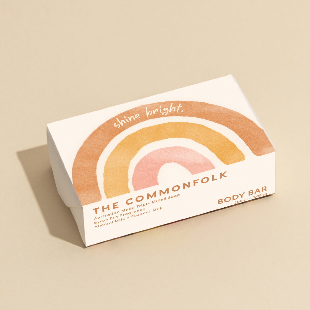 The Commonfolk 200g body bar soap features a multicolored design on the wrapping with the text 'Shine Bright' on the top.